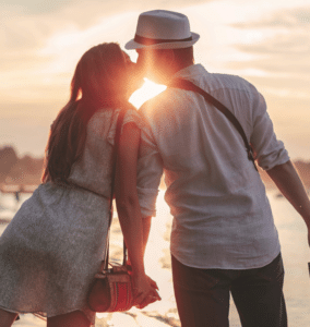 Relationship therapy success: a happy couple kissing after working through issues with a professional relationship therapist.