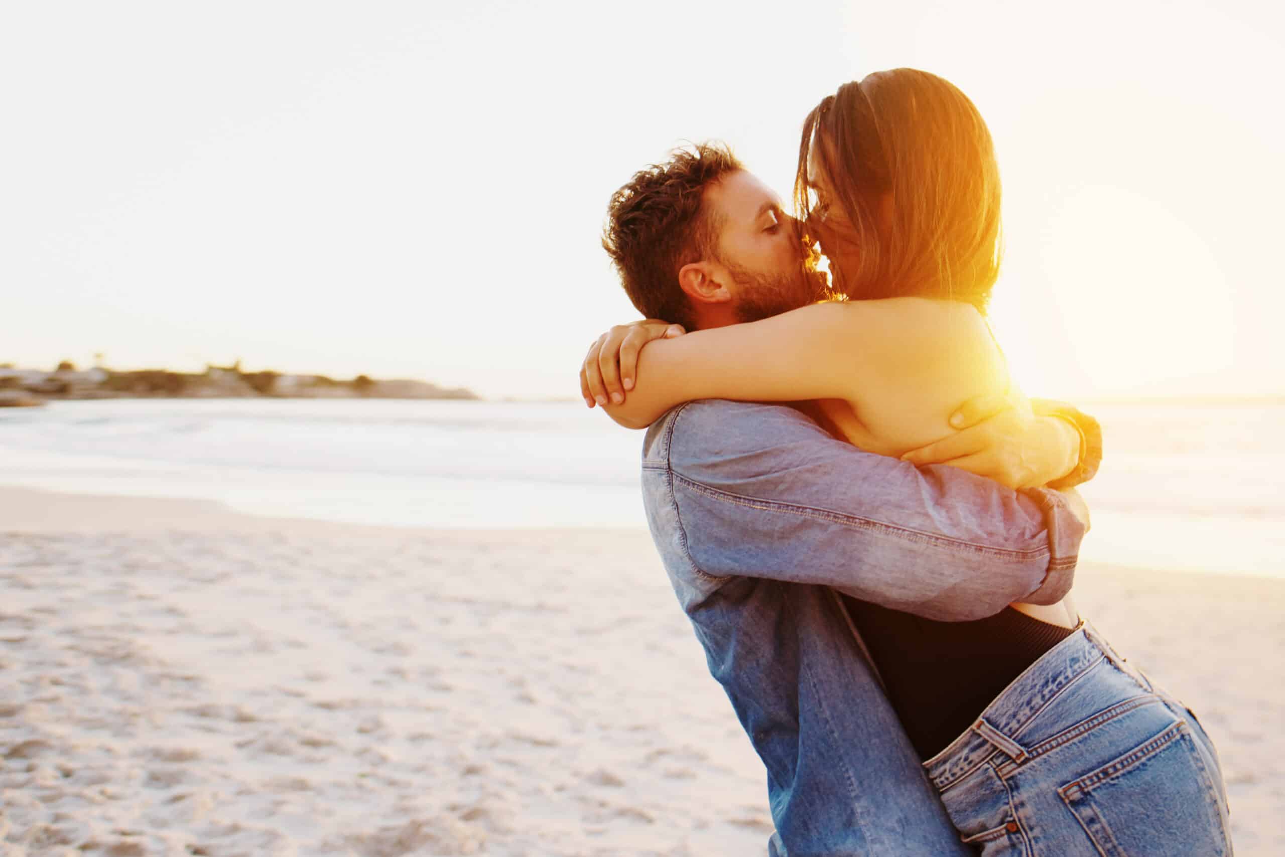 four people walking down a dirt path in a pine forest.