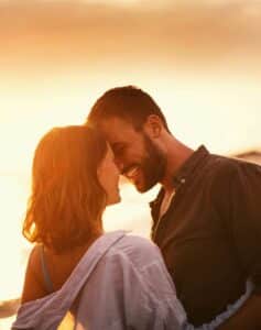 Couple running into ocean waves, couples therapy, Los Angeles, relationship goals, communication skills, beach sunset joy