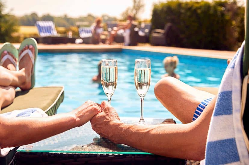 couple holding hands in the pool