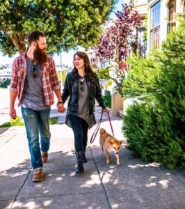 Happy couple walking dog together after successful couples therapy, San Francisco, CA, relationship healing  