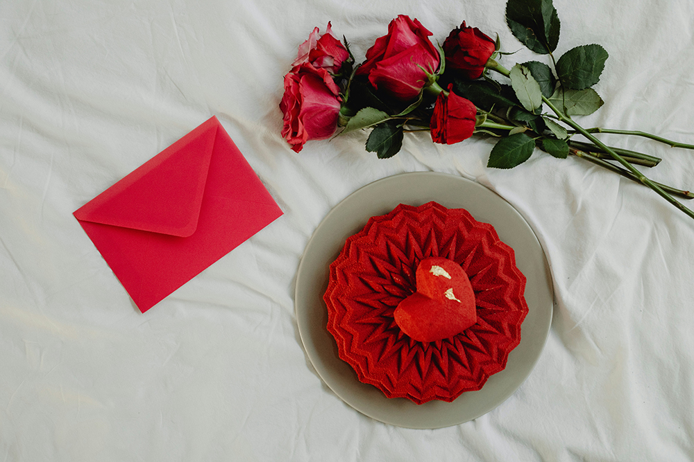 A Red Heart-Shaped Cookie Next to a Red Rose