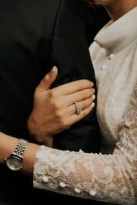 Viewed from inside a car, a smiling man and woman