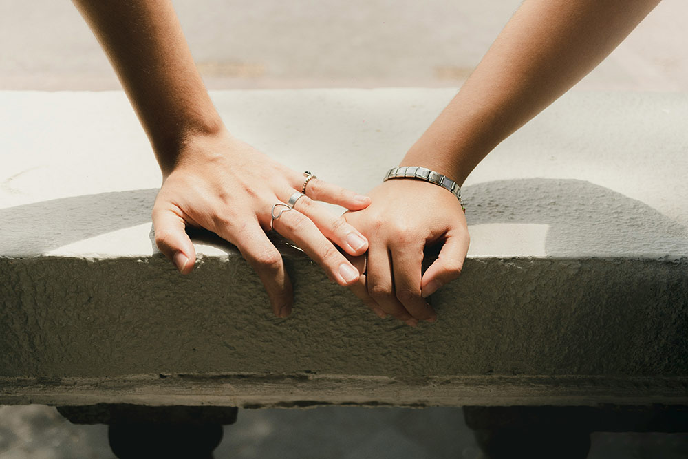 A woman uses a vintage camera to take a photo while a man standing next to her