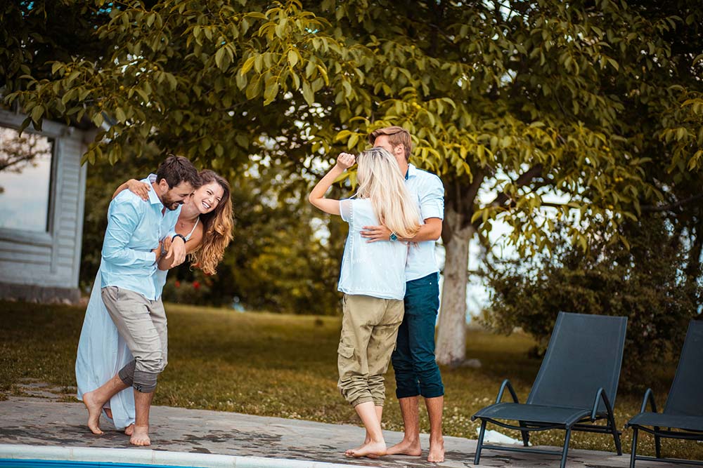 Friends having fun together by the pool. 
