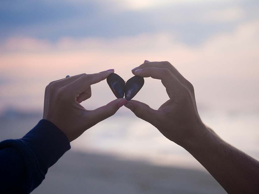 Person Holding Black Stones