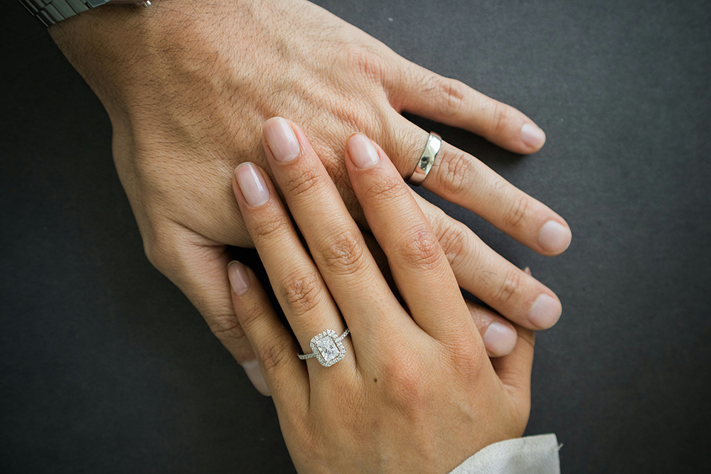 a close up of two people holding hands