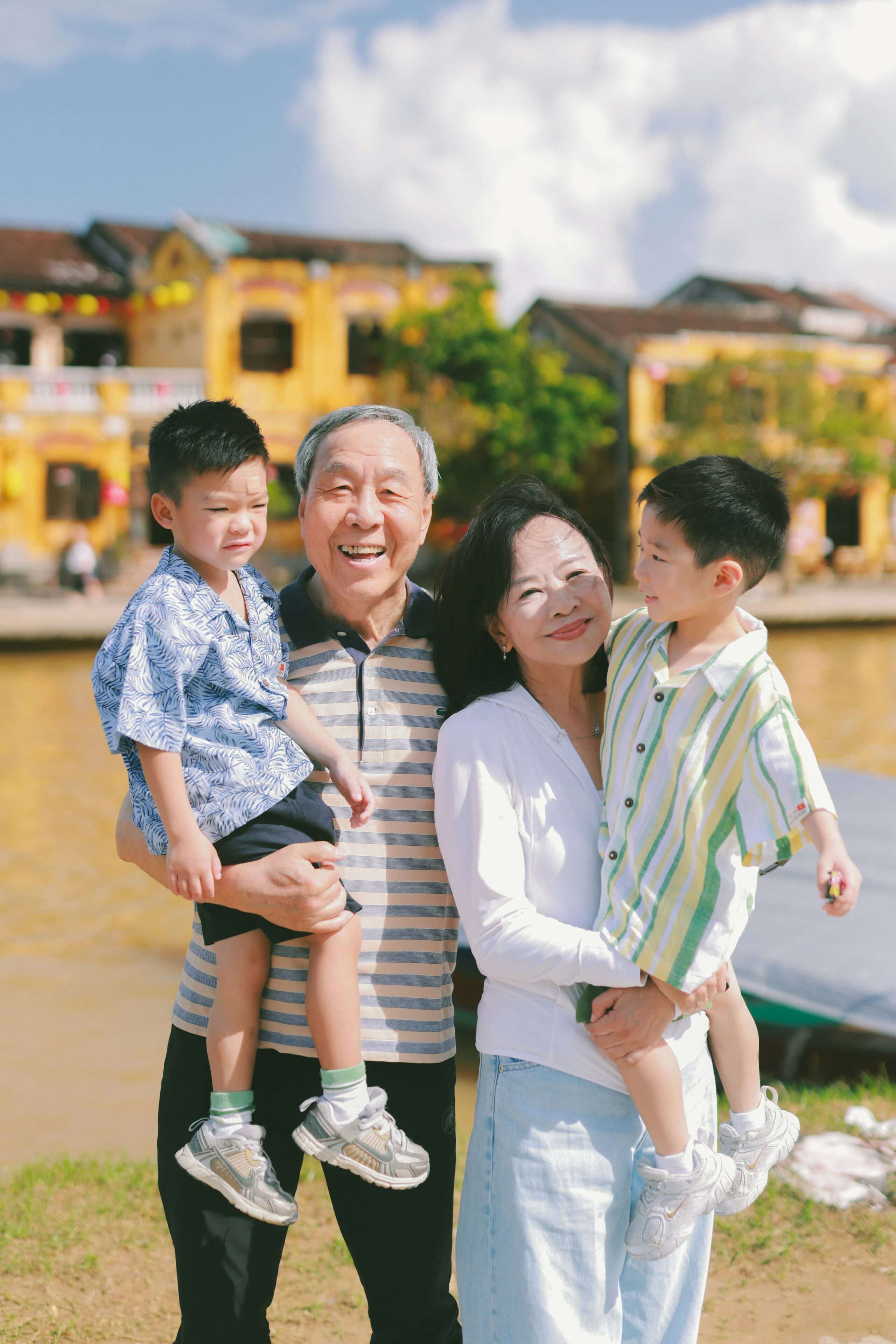 A couple shares a cozy, candlelit moment inside a small tent at night.