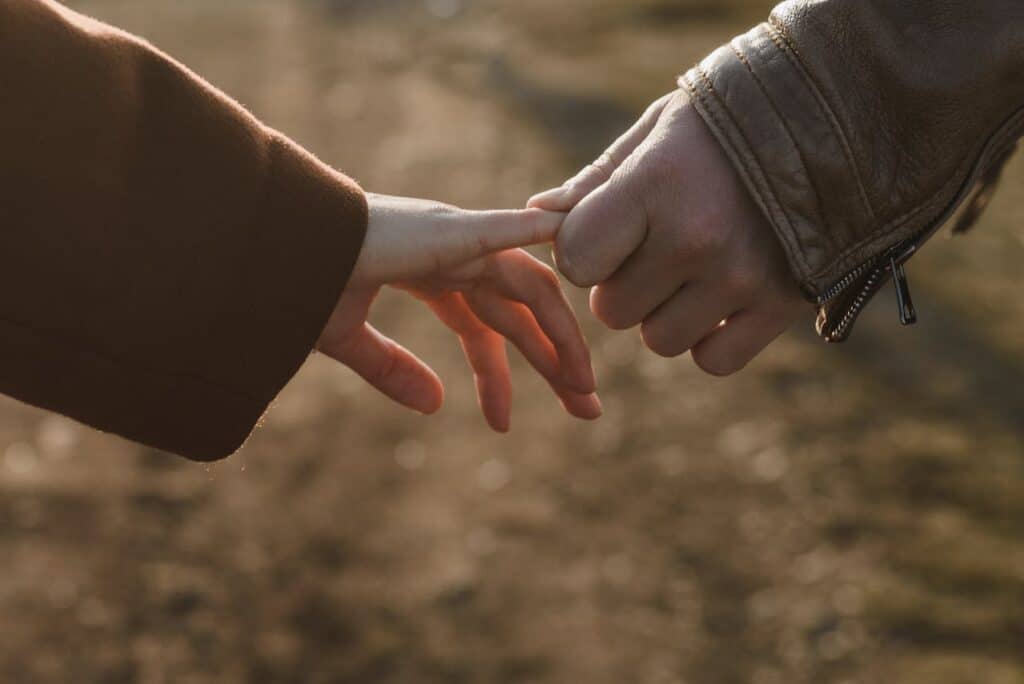 Couple gently touching hands symbolizing emotional connection and premarital doubts in Houston