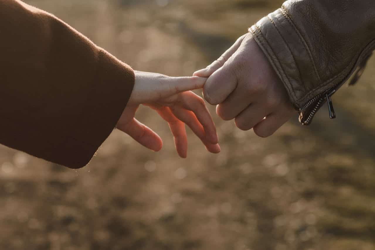 Couple gently touching hands symbolizing emotional connection and premarital doubts in Houston