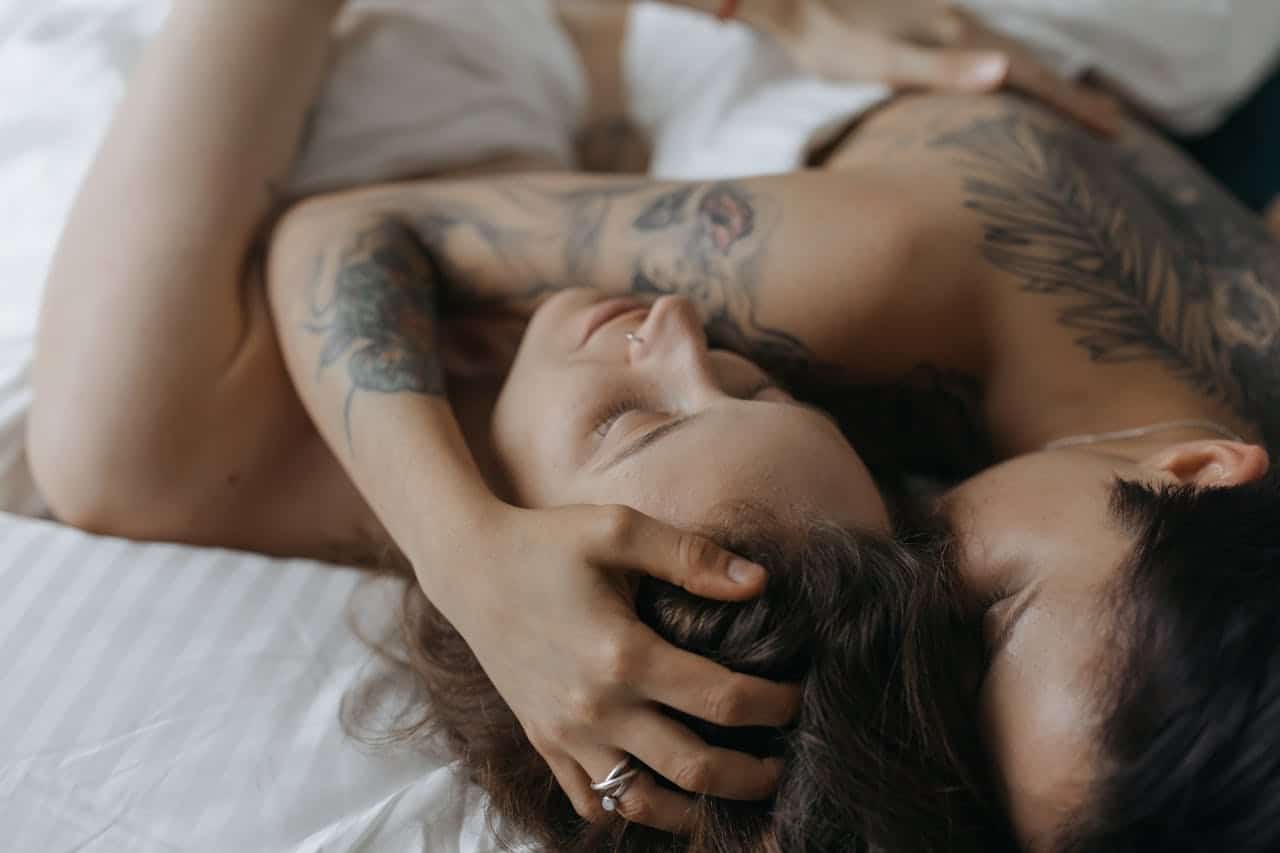 Couple lying close together showing intimacy and emotional connection, representing sex therapy and relationship healing