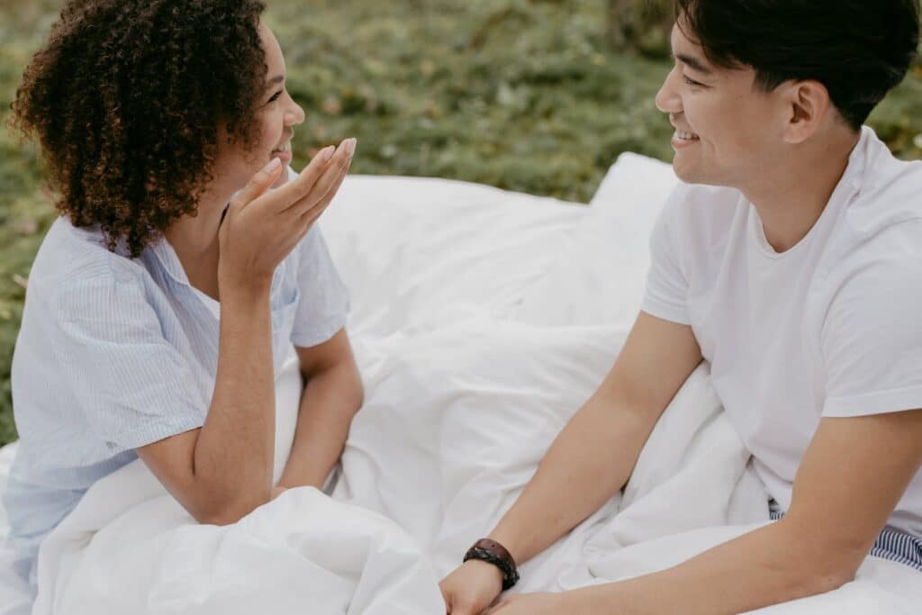 Couple talking openly and smiling, showing emotional connection beyond communication issues in marriage