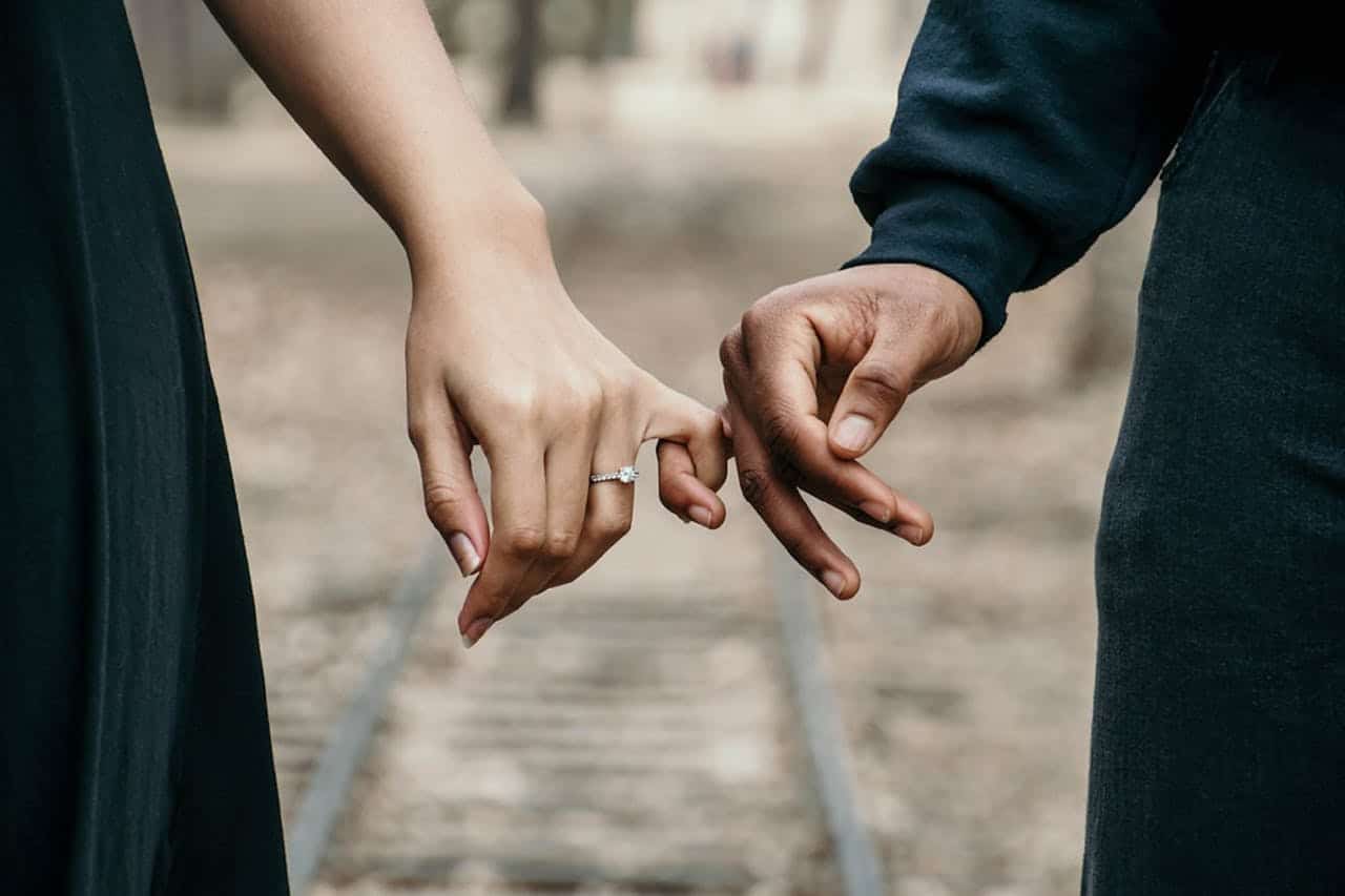 Engaged couple holding hands showing intimacy and uncertainty before marriage in Houston
