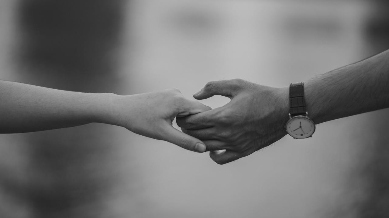 Couple holding hands symbolizing connection and trust during marriage counseling in California