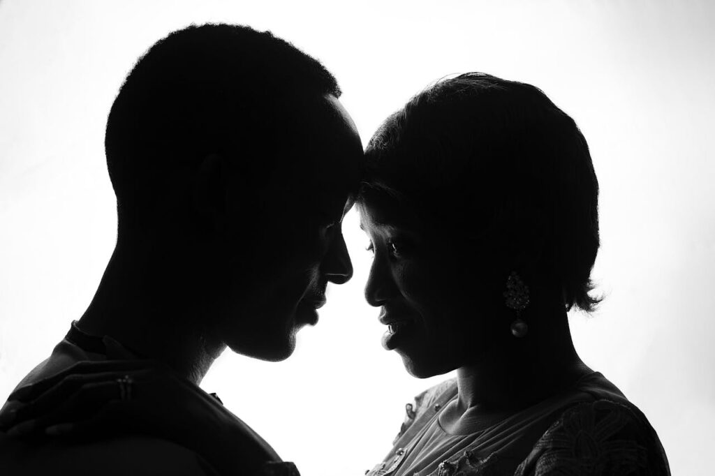 Couple leaning forehead to forehead in a quiet intimate moment symbolizing emotional connection and sexual intimacy challenges in relationships
