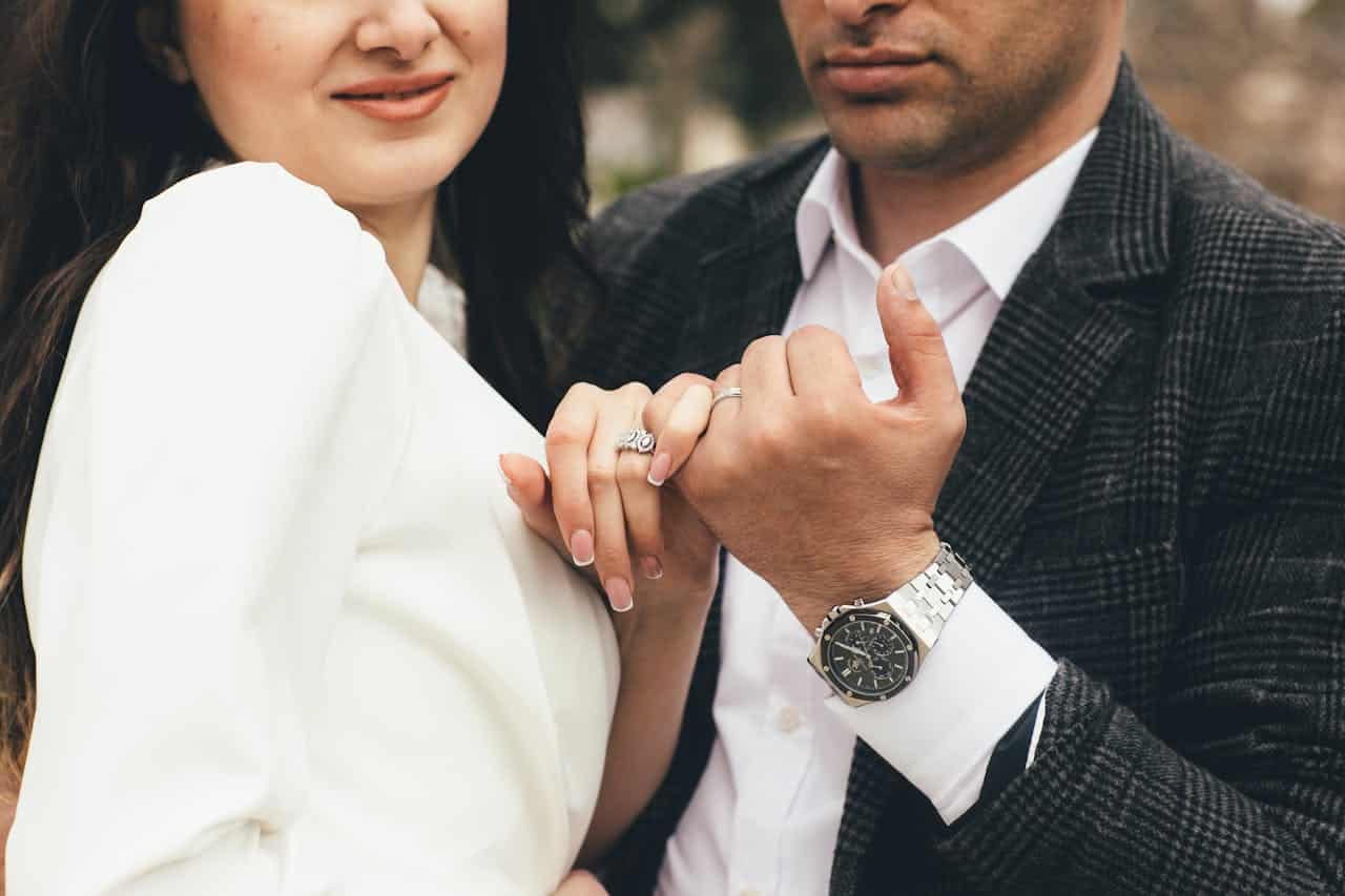 Dallas engaged couple holding hands showing ring, symbolizing premarital power struggles and relationship dynamics