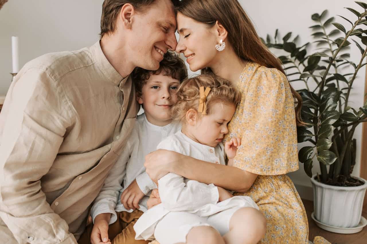 A Florida couple hugging their children at home, showing emotional closeness and family connection.