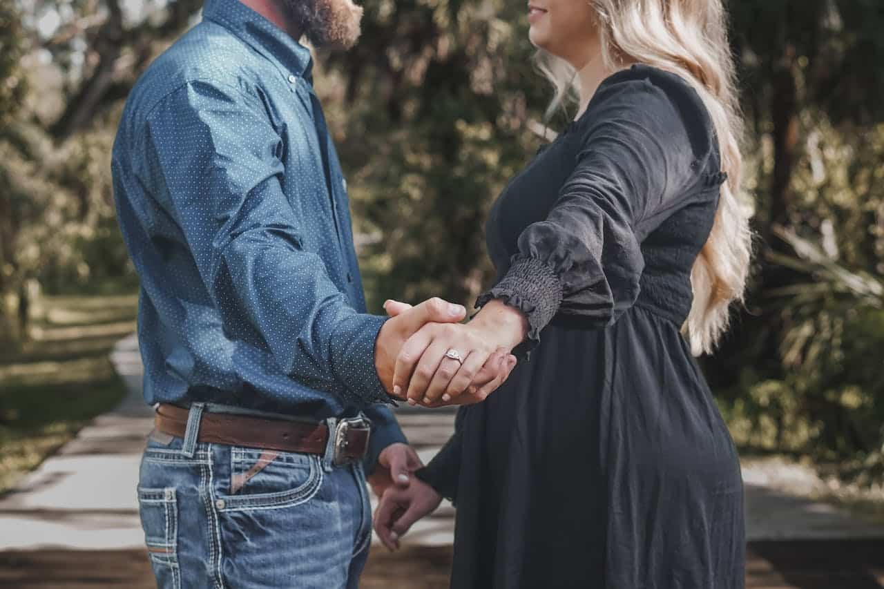 couple holding hands outdoors feeling emotionally disconnected before marriage