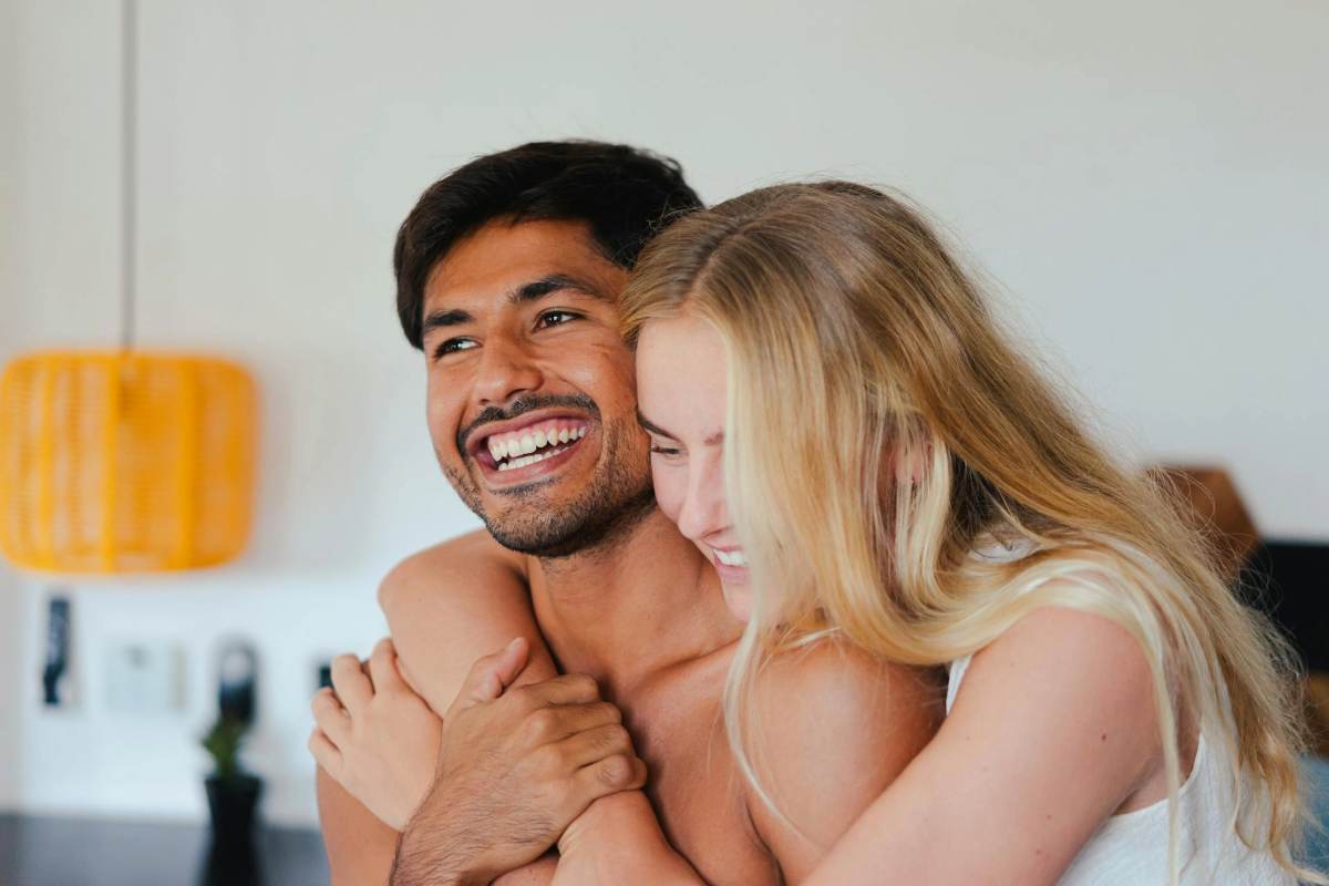 Happy couple embracing and smiling after reconnecting through emotionally focused therapy in San Diego.