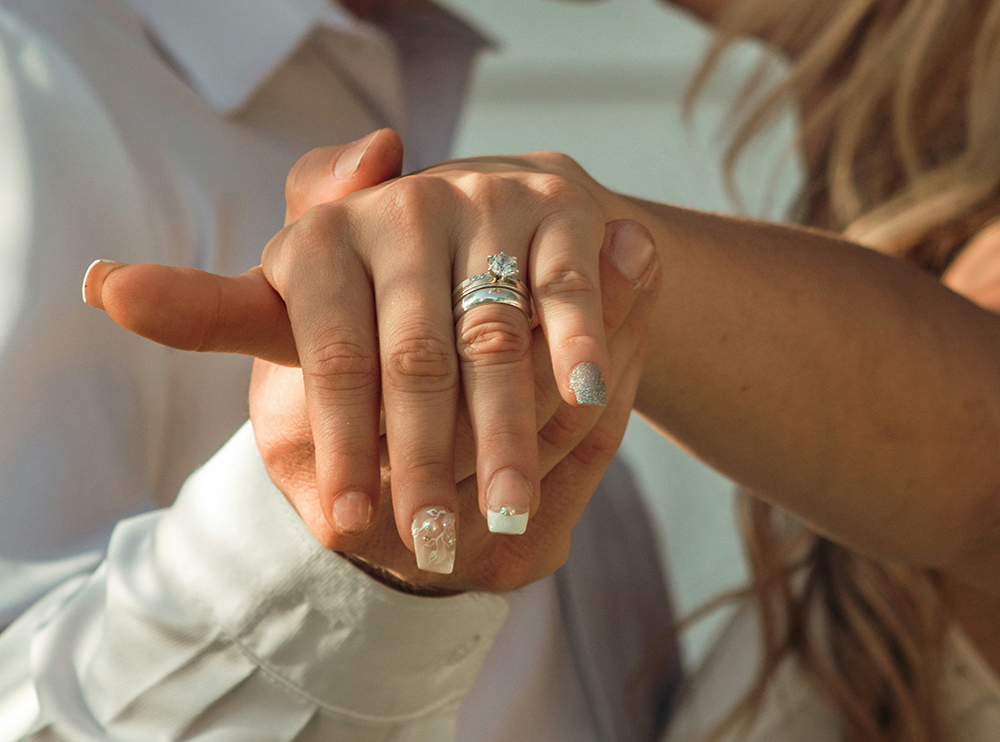 woman in white dress shirt wearing silver ring